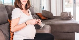 pregnant woman seated on a waiting cabinet