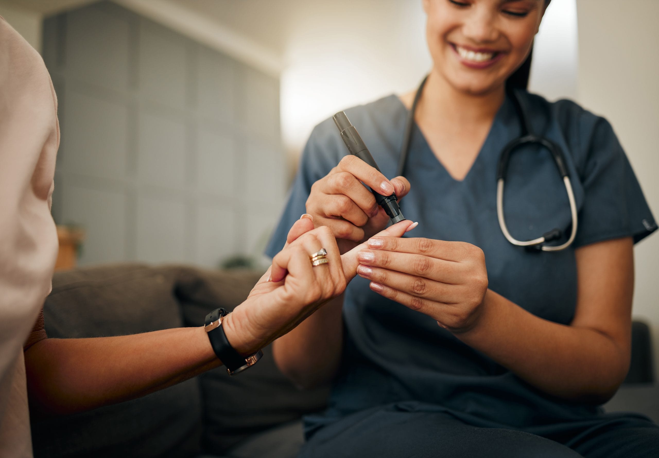 nurse pricking the finger to take a sample from the patient 